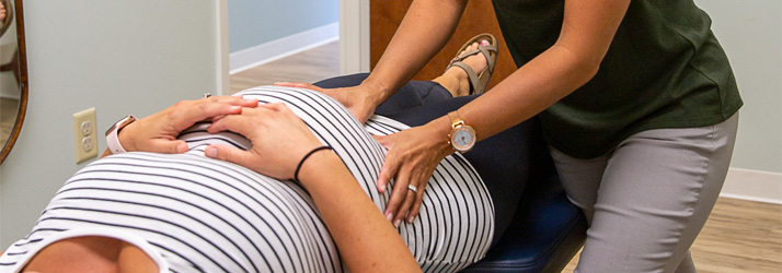 Pregnant-lady-on-kneeling-chair - Community Chiropractic