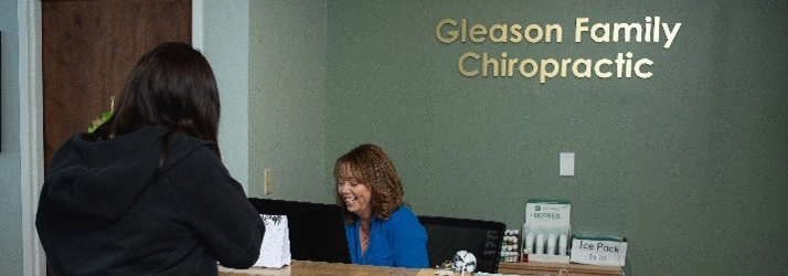 Chiropractic Amherst NY Front Desk With Patient